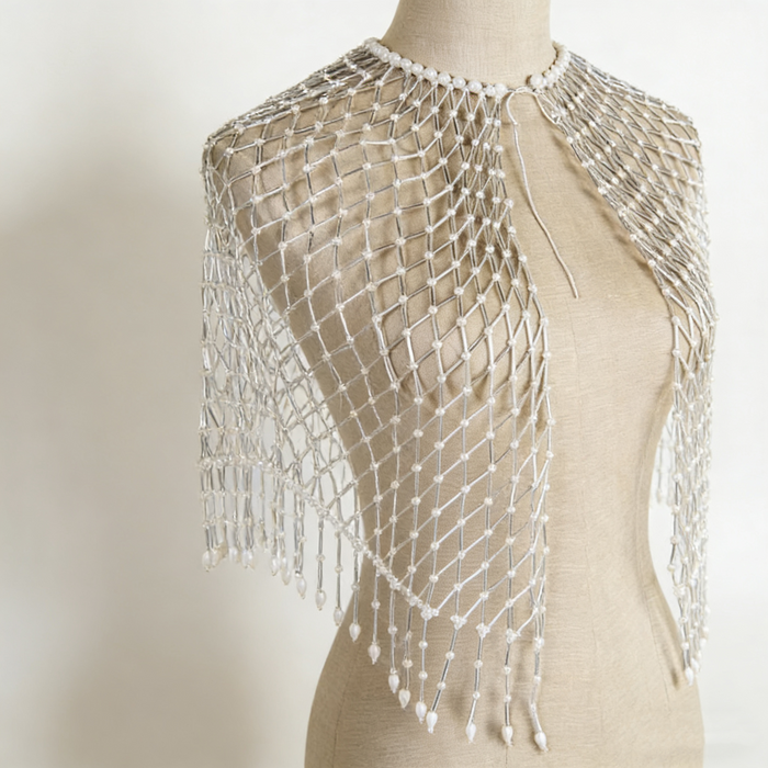 Handwoven pearl beaded bridal cape with geometric seed bead pattern and pearl fringe.