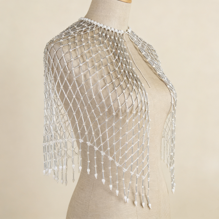 Handwoven pearl beaded bridal cape with geometric seed bead pattern and pearl fringe.