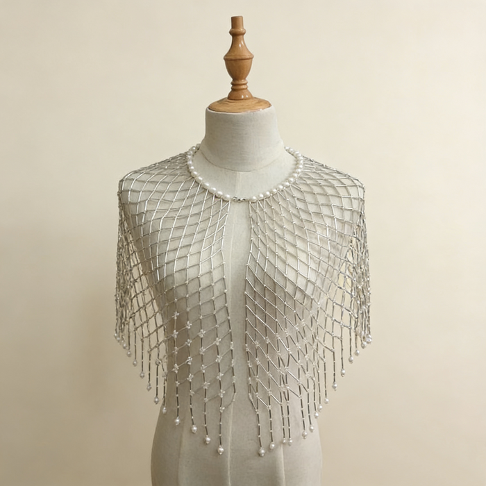 Handwoven pearl beaded bridal cape with geometric seed bead pattern and pearl fringe.