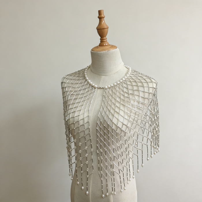 Handwoven pearl beaded bridal cape with geometric seed bead pattern and pearl fringe.