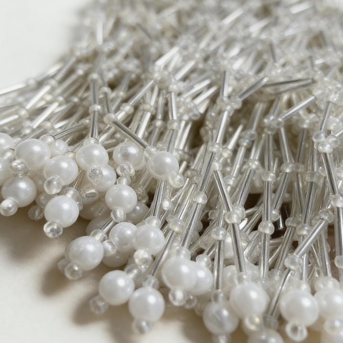 Handwoven pearl beaded bridal cape with geometric seed bead pattern and pearl fringe.