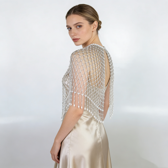 Luxury handmade bridal cape featuring pearl beads and delicate woven beadwork.