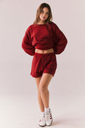 Crimson red drawstring lounge shorts in pillow terry fabric.