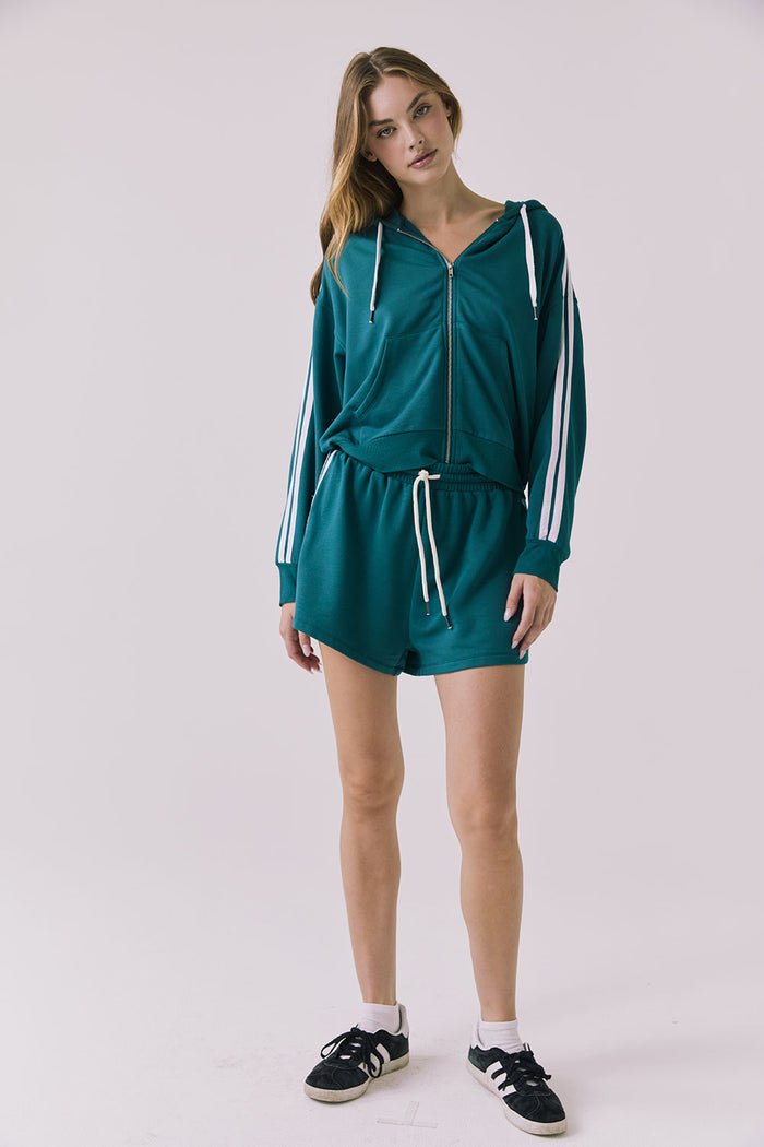 Chaser Abilenee Teal Zip Up with White Stripes shown with matching Hanoverr Shorts in a clean full body studio frame