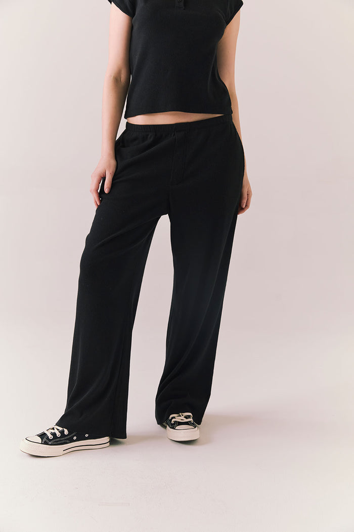 True black fleece joggers with side pockets and relaxed silhouette.