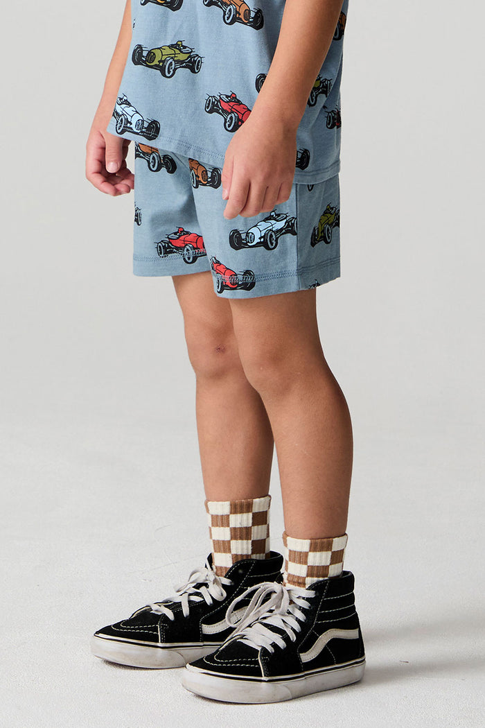 Side angle view of a boy wearing the Chaser Have a Nice Day Shorts on a neutral background