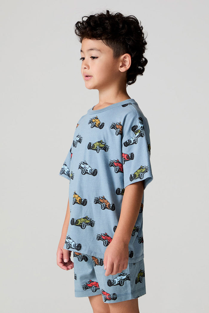 Side angle view of a boy wearing the Chaser Have a Nice Smile Tee on a neutral background