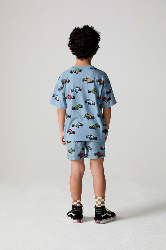 Full body back view of a boy wearing the Chaser Have a Nice Smile Tee on a neutral background