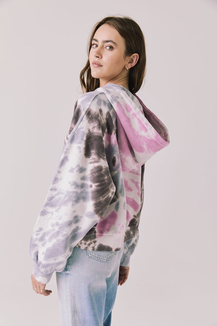 Back view of woman wearing Chaser’s Heart Tie Dye Zip Up Hoodie on a white background