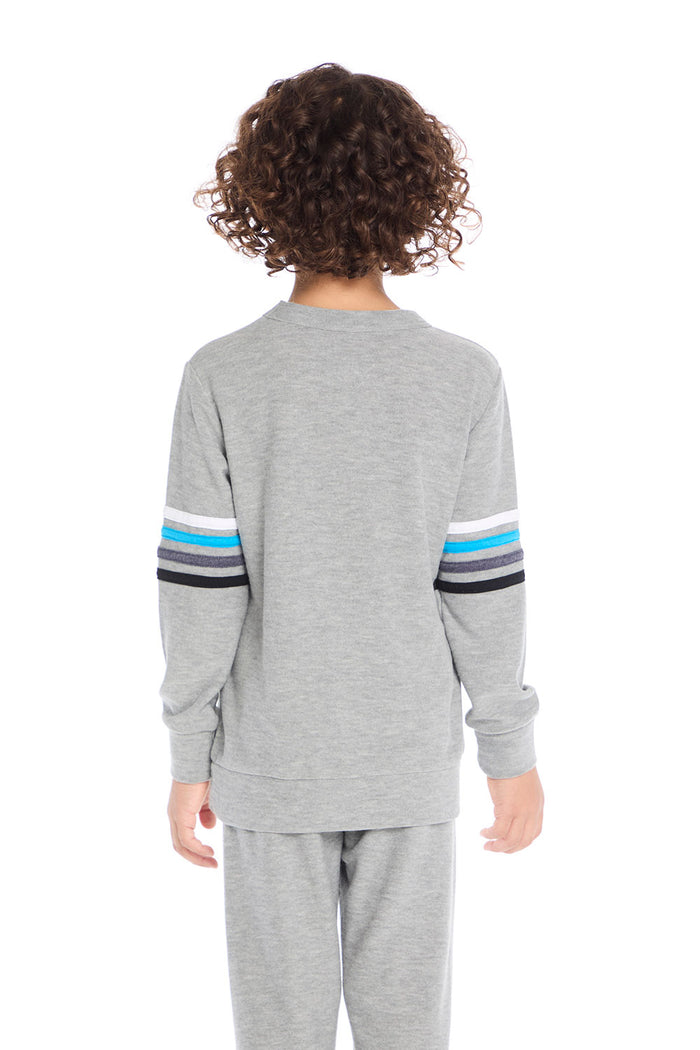 Back view of boy wearing Chaser Kids Heather Grey Long Sleeve Pullover with multicolor sleeve stripes, white background