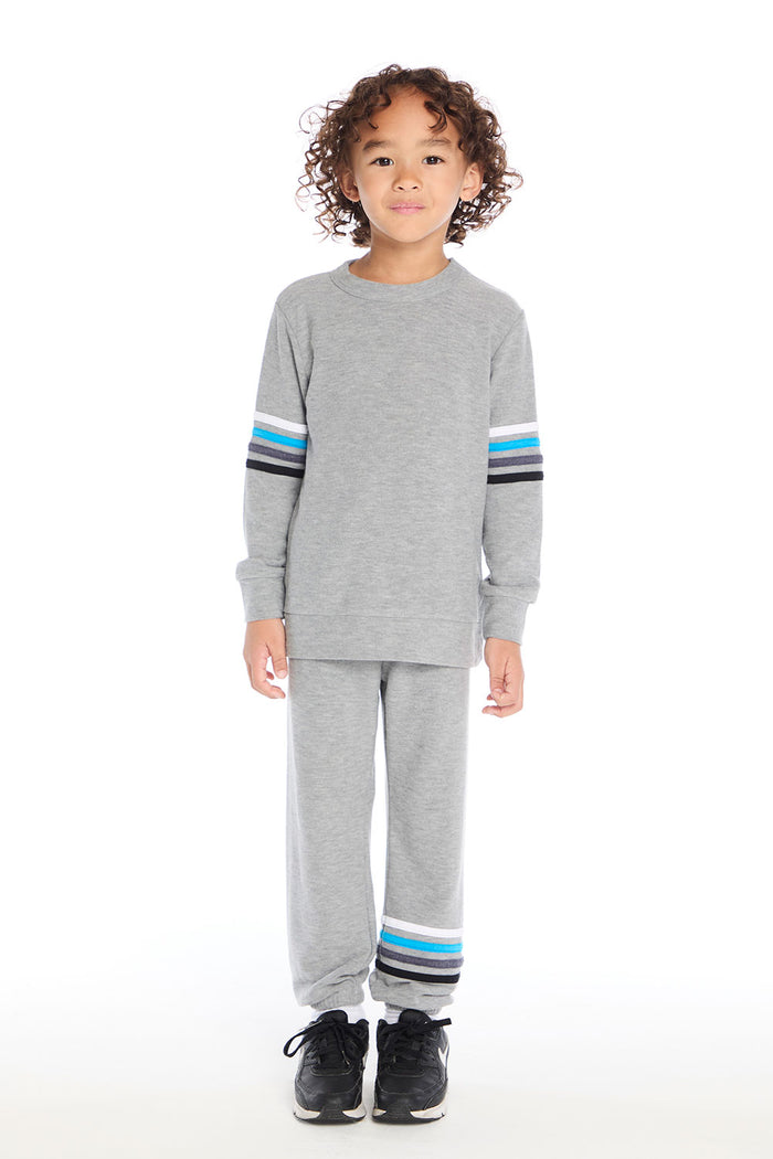 Boy wearing Chaser Kids Heather Grey Long Sleeve Pullover paired with matching Heather Grey Joggers, full body view on a white background