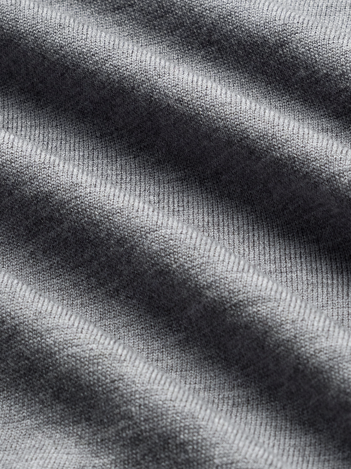 Close-up of heather grey sweater knit fabric with soft folds