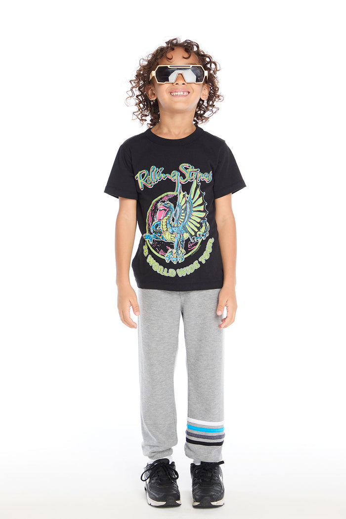 Full body view of boy wearing Chaser Kids Heather Grey Joggers and Rolling Stones Dragon Tee, styled with black sneakers and white socks on a white background