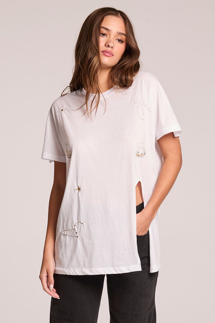 Front view of a woman wearing the Chaser  High Desert Tee and jeans on a neutral background