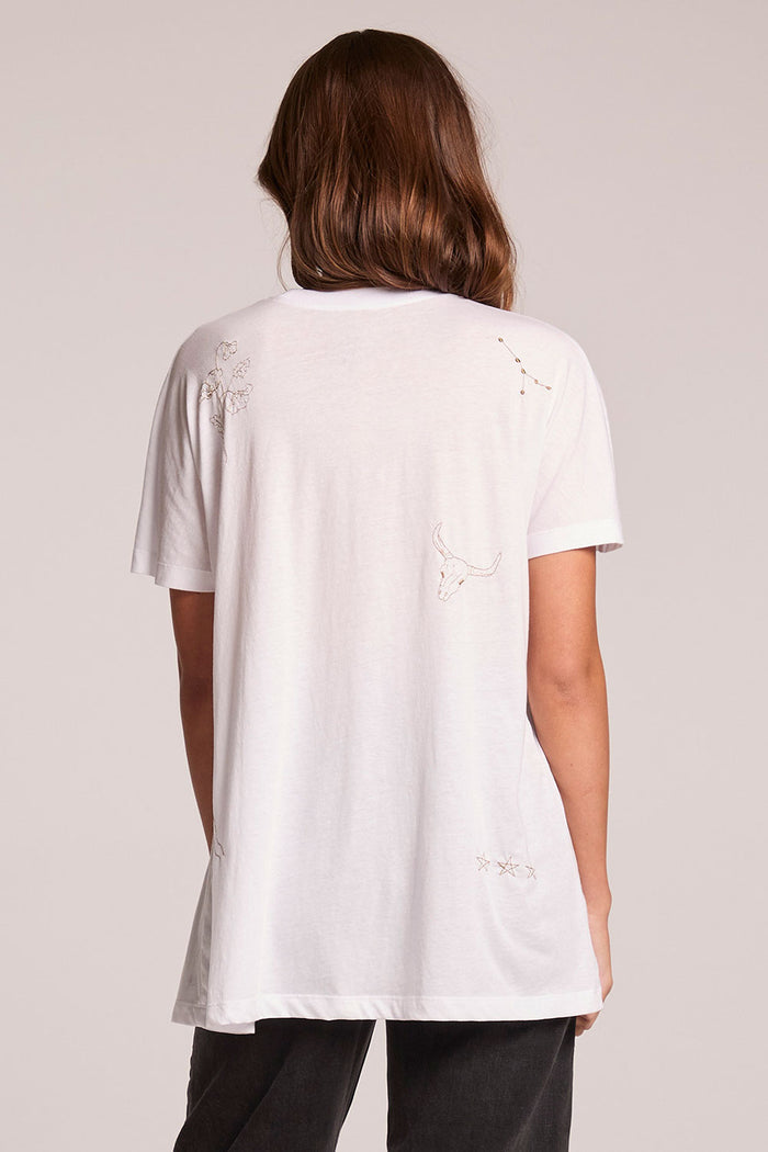 Back view of a woman wearing the Chaser  High Desert Tee on a neutral background