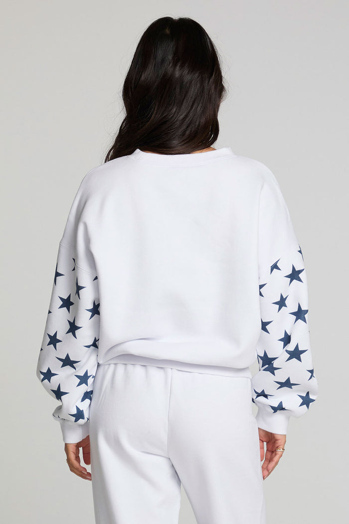 Back view of a woman wearing the Chaser   High Spirits Long Sleeve on a neutral background