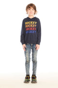 Full body view of boy wearing Chaser’s Hockey navy blue pullover hoodie with ‘Hockey’ text and distressed jeans on a white background