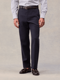 Admiral navy suit pants worn with a brown belt and tassel loafers, cropped waist-to-shoe view.