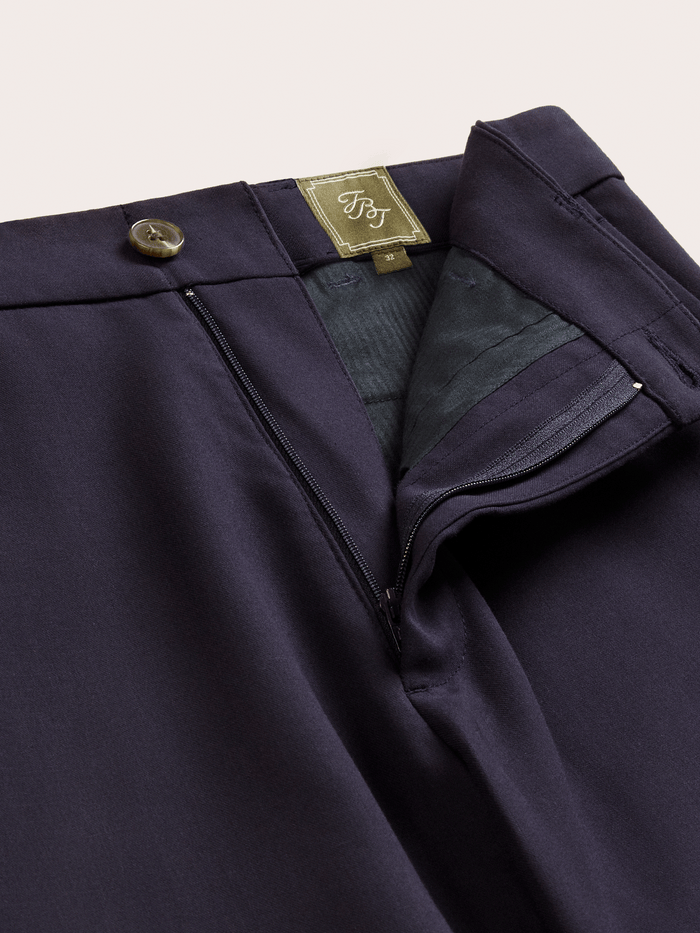 Admiral navy suit pants with the fly open, showing zip closure and interior brand label.