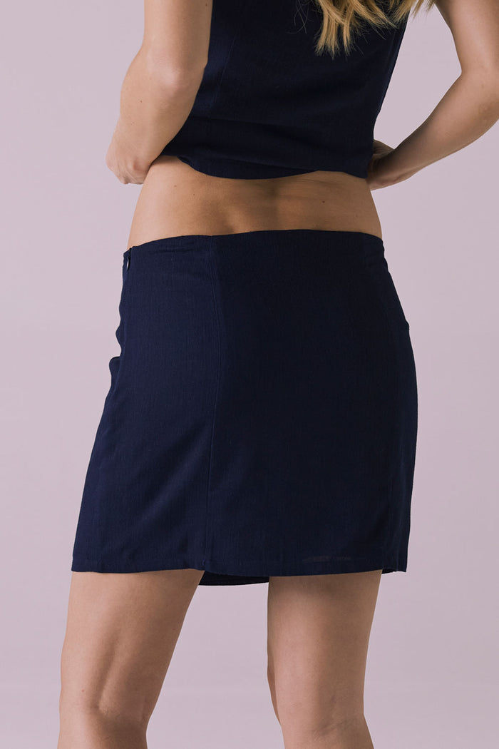 Back view of Chaser Ibiza Navy Mini Skirt showing straight hemline and fitted shape