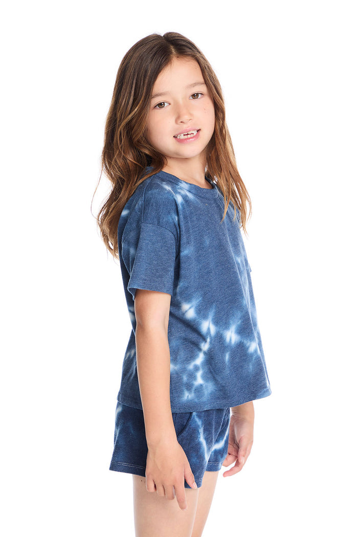 Side view of the Chaser Kids Indigo Heart Tie-Dye T-Shirt showing the casual drop-shoulder fit and blue-and-white tie-dye design