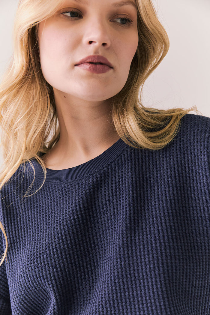 Front view of model in Irvine Tee in midnight blue with soft thermal texture on plain background