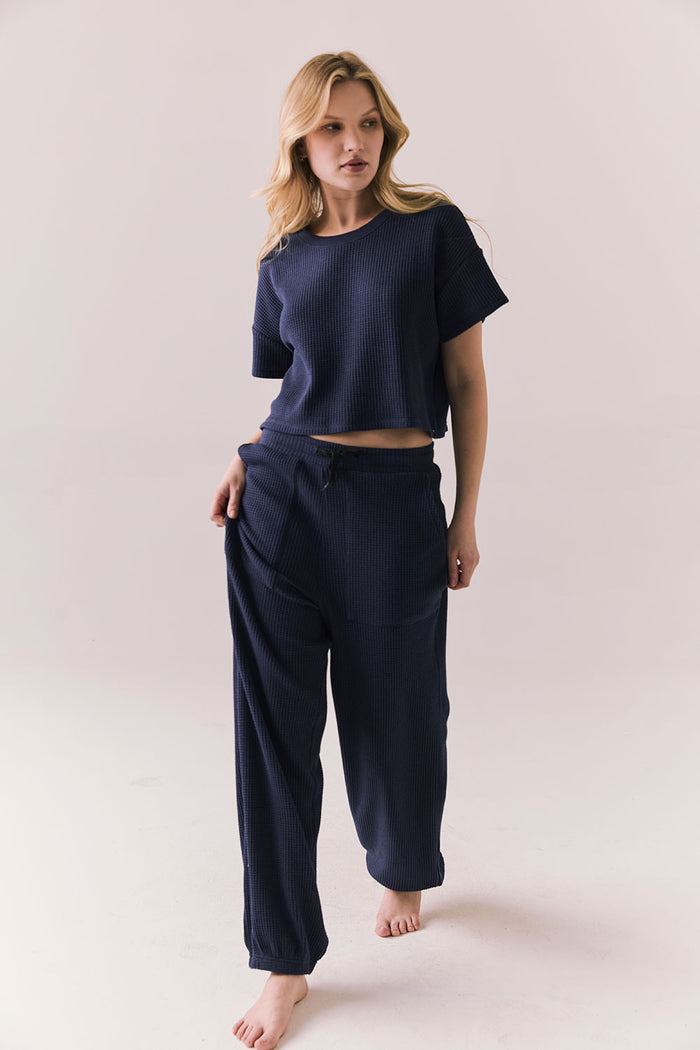 Full front view of model in Irvine Tee in midnight blue with soft thermal texture and matching Billy Joggers against a plain background