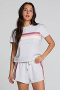 Front view of a woman wearing the Chaser  Isla Light Heather Grey Tee on a neutral background