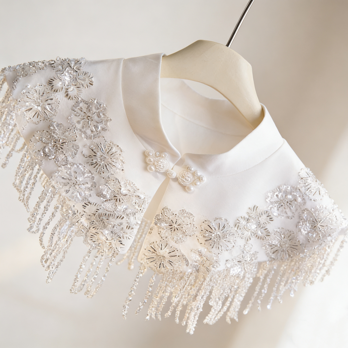 Ivory beaded bridal capelet with sequin embroidery and fringe details, luxury short wedding shawl for bridal gown.