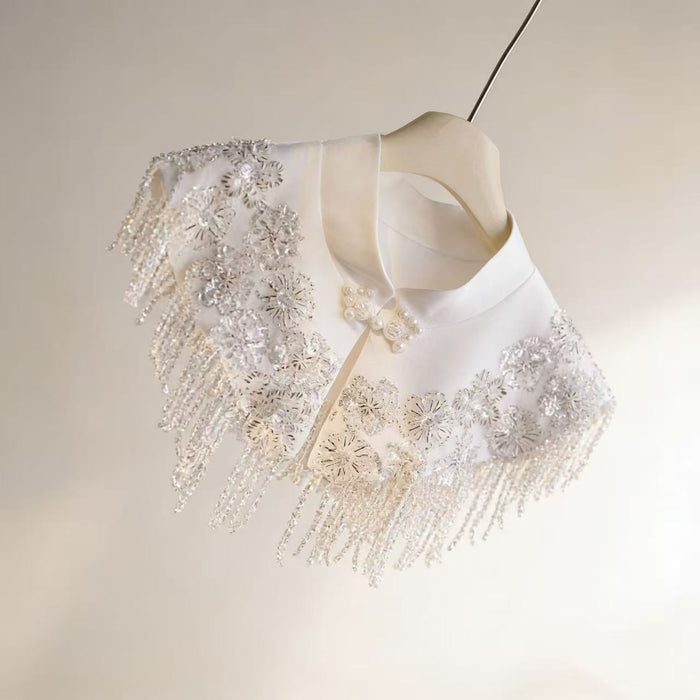 Ivory beaded bridal capelet with sequin embroidery and fringe details, luxury short wedding shawl for bridal gown.