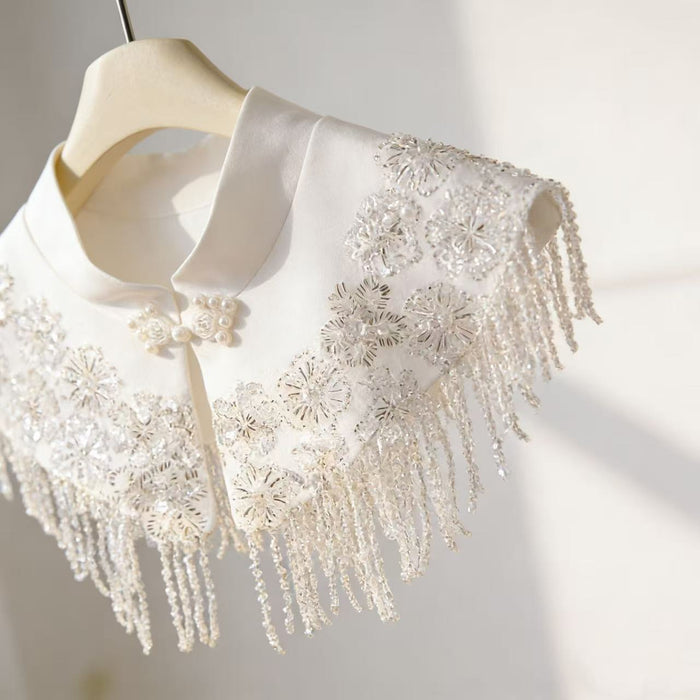 Ivory beaded bridal capelet with sequin embroidery and fringe details, luxury short wedding shawl for bridal gown.
