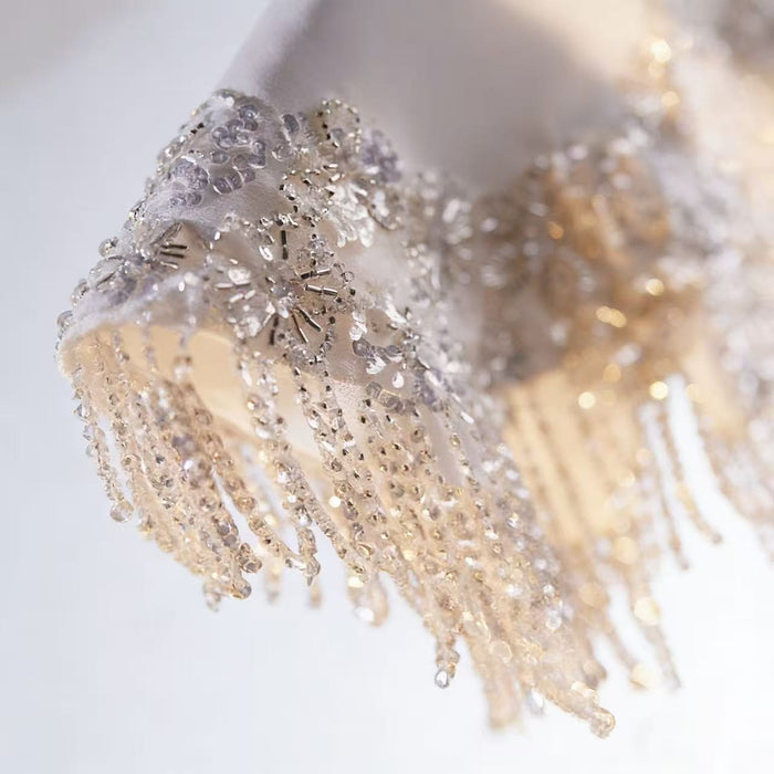 Ivory beaded bridal capelet with sequin embroidery and fringe details, luxury short wedding shawl for bridal gown.