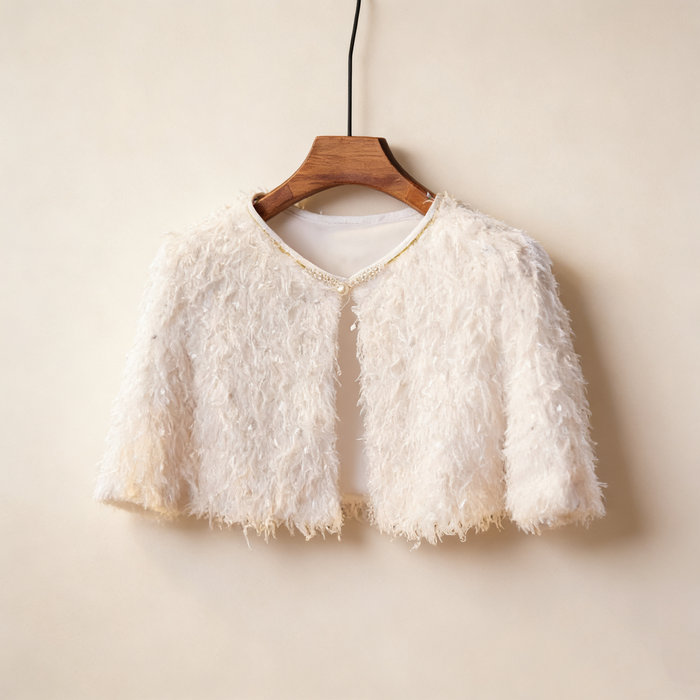Luxury ivory feather bridal capelet handcrafted with soft layered feathers for elegant wedding dresses.
