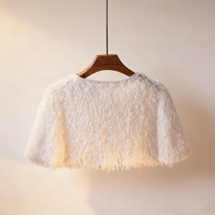 Luxury ivory feather bridal capelet handcrafted with soft layered feathers for elegant wedding dresses.