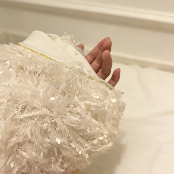 Luxury ivory feather bridal capelet handcrafted with soft layered feathers for elegant wedding dresses.