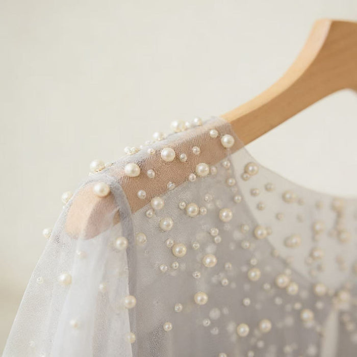 Ivory pearl bridal capelet with hand-sewn pearls and sheer chiffon tulle, elegant wedding dress shoulder cover.