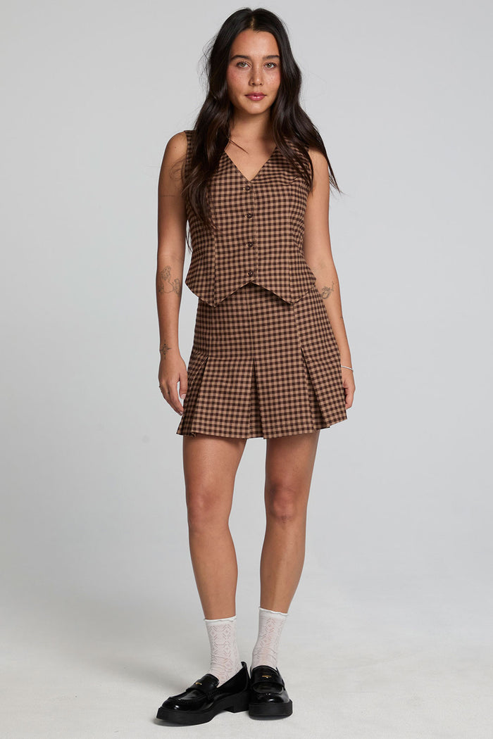 A full body front view of a woman wearing the Chaser Ivy Choco Check Skort on a neutral background