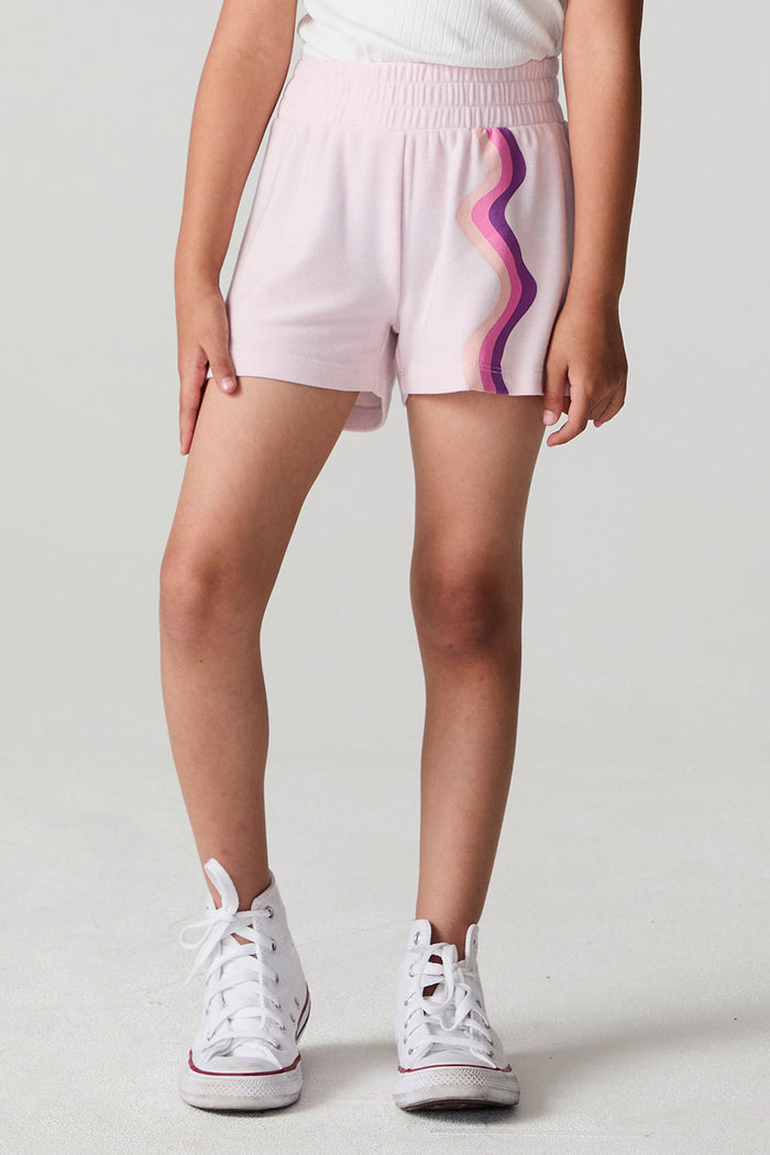 Front view of a girl wearing the Chaser Jade Begonia Shorts on a neutral background