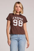 Front view of a woman wearing the Chaser   J'adore 98 Tee and jeans on a neutral background
