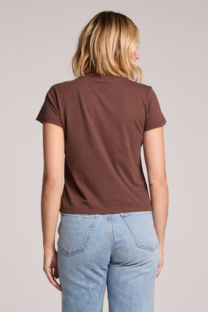Back view of a woman wearing the Chaser   J'adore 98 Tee on a neutral background