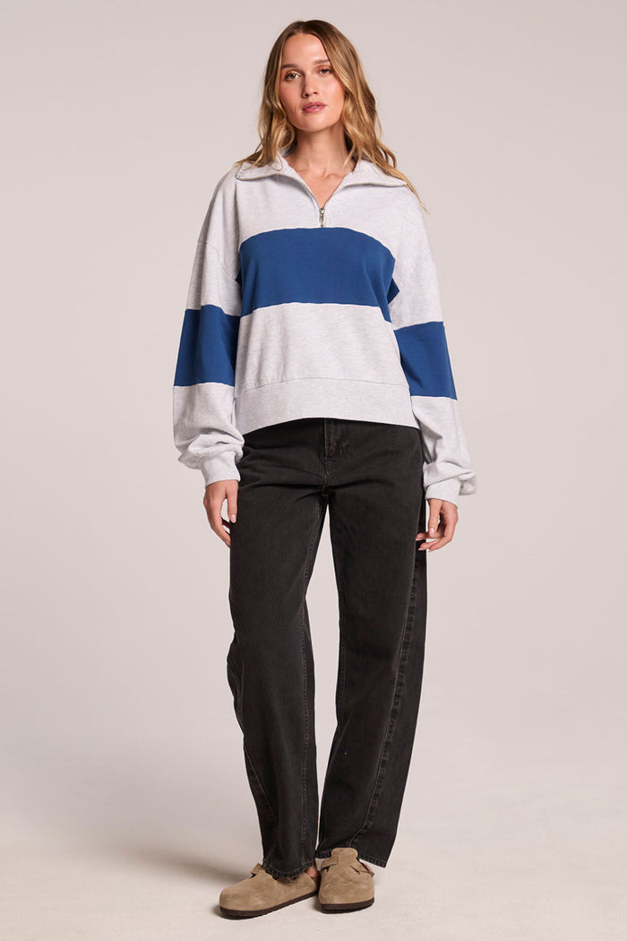 Full body front view of a woman wearing the Chaser  Jaime Admiral and Grey Half Zip and clogs on a neutral background