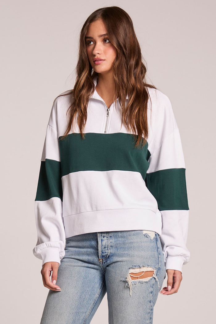 A front view of a woman wearing the Chaser Jaime Pine and White Half Zip on a neutral background with hands at her sides