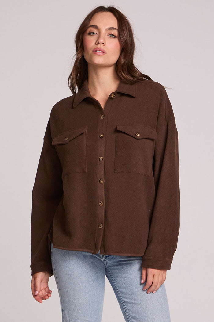 Front view of a woman wearing the Chaser Jaxxon Wood Brown Shacket on a neutral background