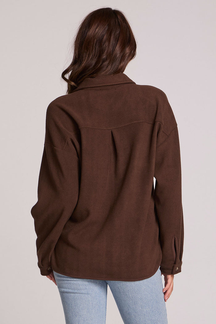 Back view of a woman wearing the Chaser Jaxxon Wood Brown Shacket on a neutral background with arms at sides