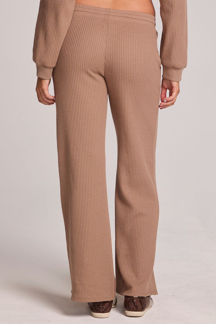 Back view of a woman wearing the Chaser Jorgia Camel Pants on a neutral background