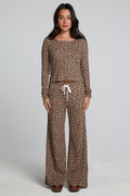 Full body front view of a woman wearing the Chaser  Jorgia Leopard Pant on a neutral background with matching top