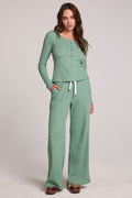 Full body front view of a woman wearing the Chaser  Jorgia Verdelle Pants on a neutral background with matching shirt