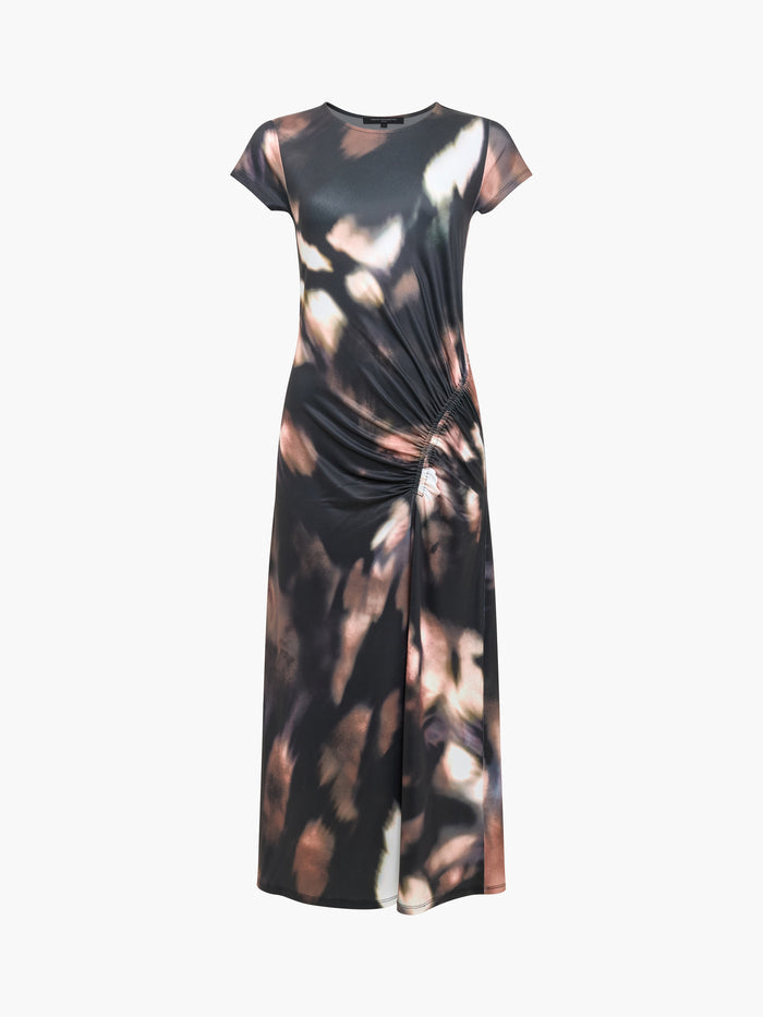 A woman wearing a short sleeved midi dress with a round neckline, a slit hem and  abstract print.