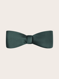 A pre-tied juniper green satin bow tie against a light neutral background