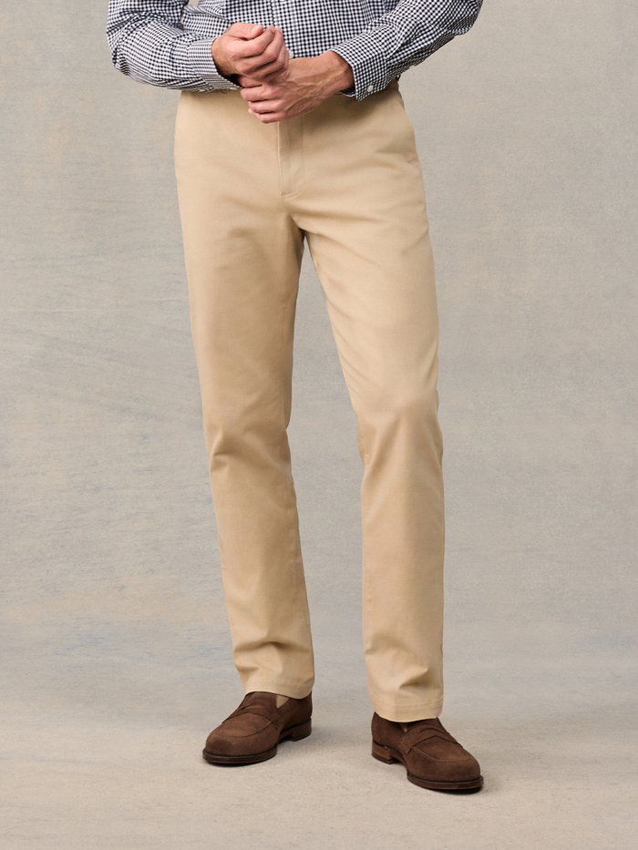 Cropped front view of khaki chino trousers with brown suede loafers